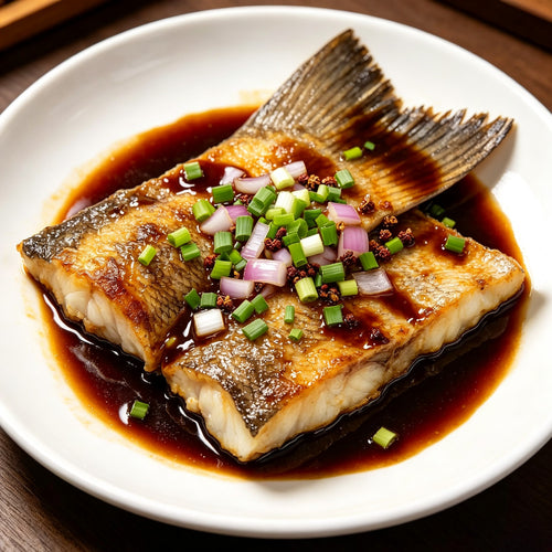 Braised cod fish tails glazed in soy sauce with spring onion