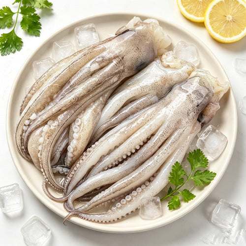 Raw squid tentacles arranged on a plate over ice